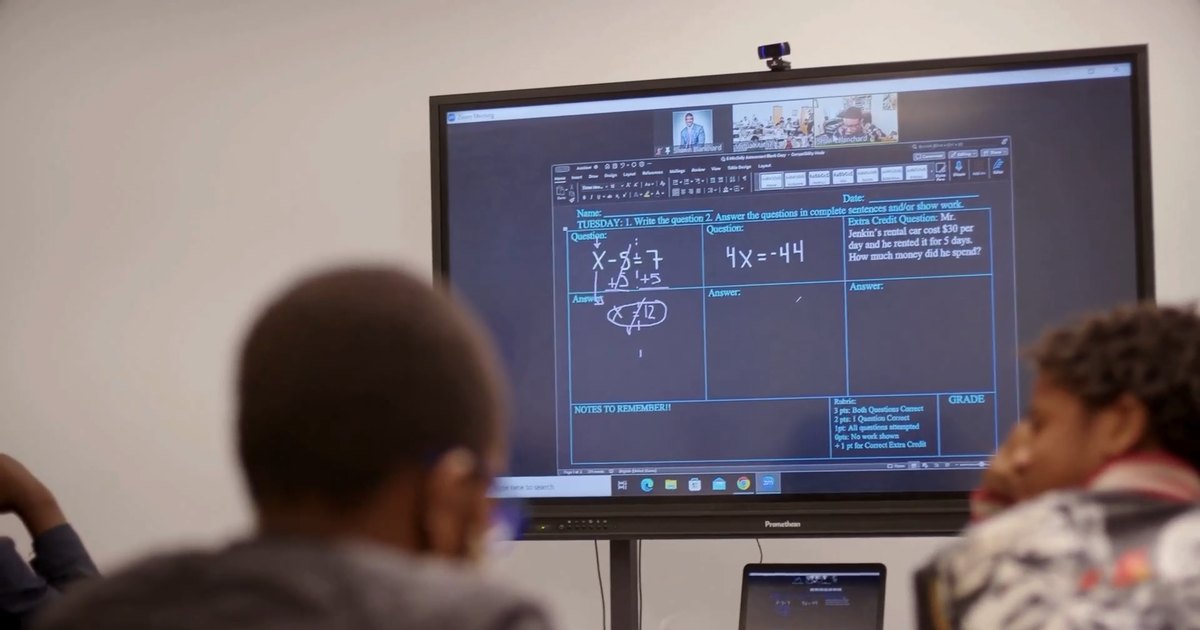 Students follow a live math lesson from their virtual teacher on the classroom screen, as in high-dosage tutoring.